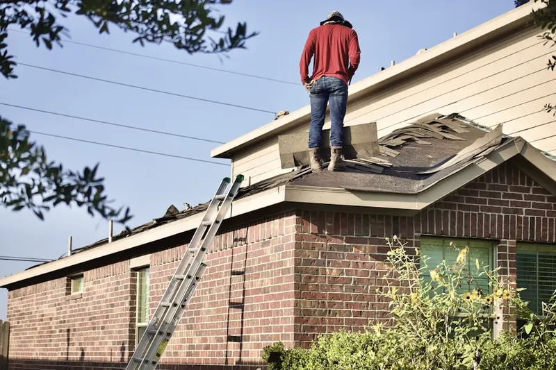 Professional roofer working on a residential roof in Littlefield